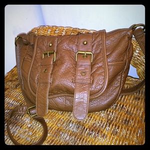Brown leather cross body purse.